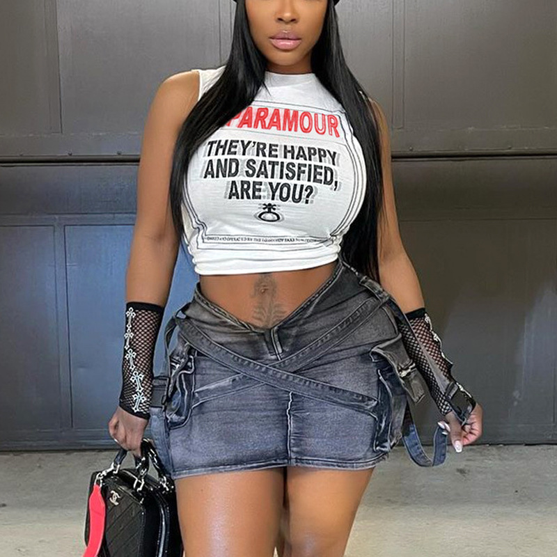 Close-up of printed letters on white lace cami top